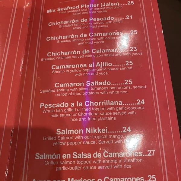 A red restaurant menu displays a variety of seafood dishes and their prices.