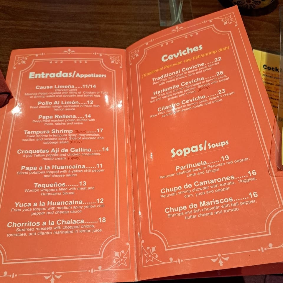 An open orange menu displays appetizers, ceviches, and soups with descriptions and prices.